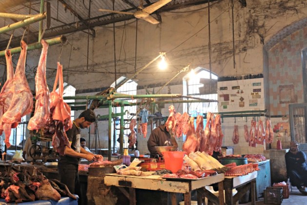 Empress Market - A Butcher cuts meat into pieces