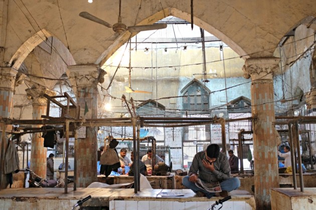 Empress Market - People start the day by reading newspaper in the meat section