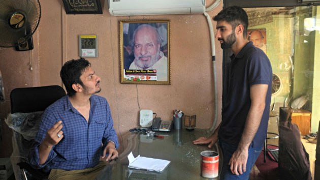1 - Waqar speaks to a customer in his office