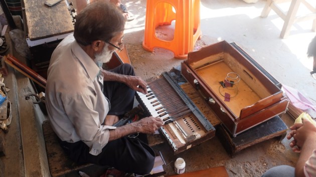 3 - Waheed repairs a harmonium in front of his shop