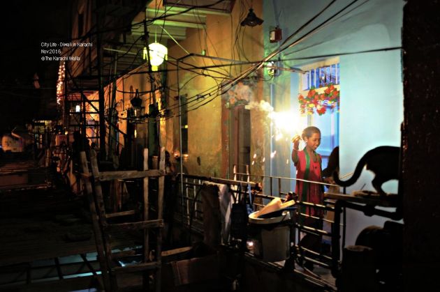 18-a-girl-takes-a-lit-up-sparkle-to-the-street-below-in-narayanpura