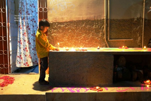 7-a-kid-lights-up-a-candle-in-front-of-his-house